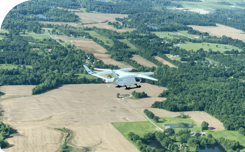 Aerial view of a mall plane flying over fields